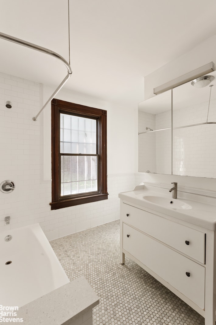 1456 Dean Street Brooklyn, NY 11213 - Photo 25 of 28 a spacious bathroom with a tub sink and mirror