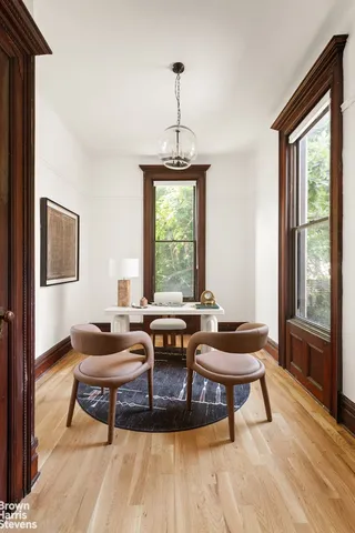 a living room with furniture and floor to ceiling windows