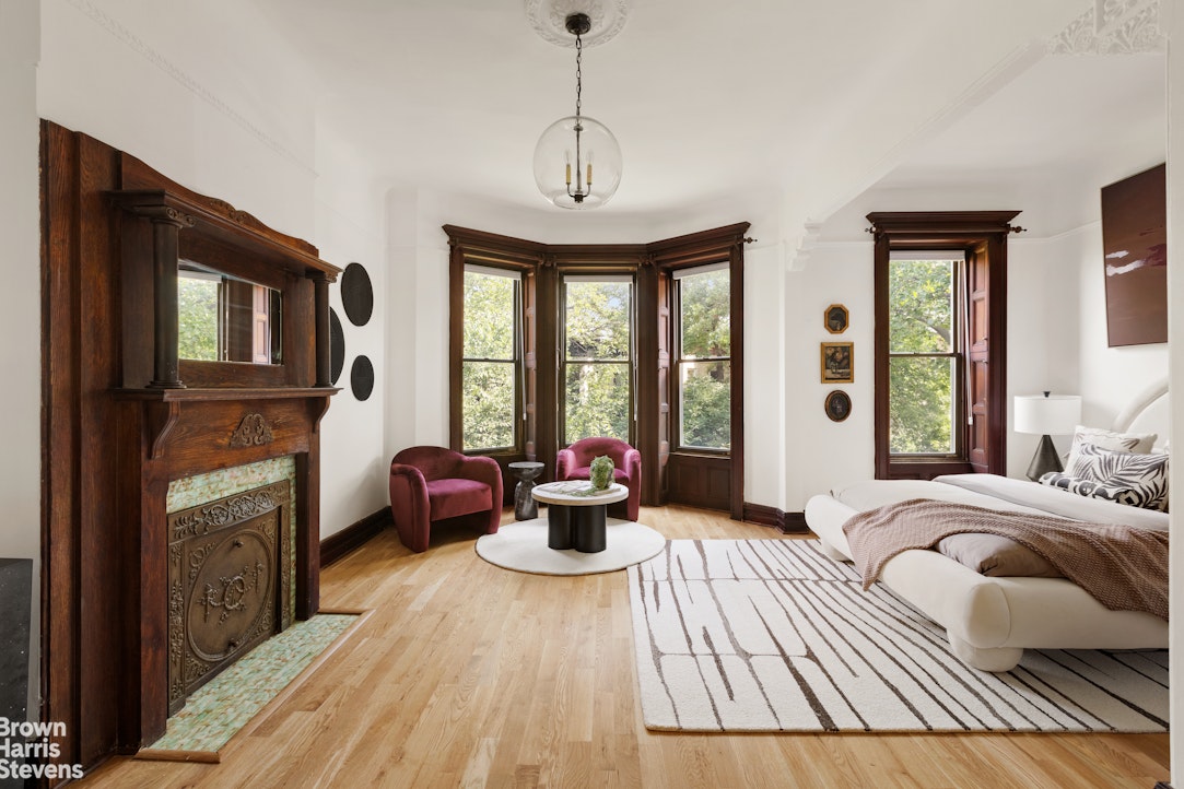 1456 Dean Street Brooklyn, NY 11213 - Photo 8 of 28 a bedroom with furniture a fireplace and windows