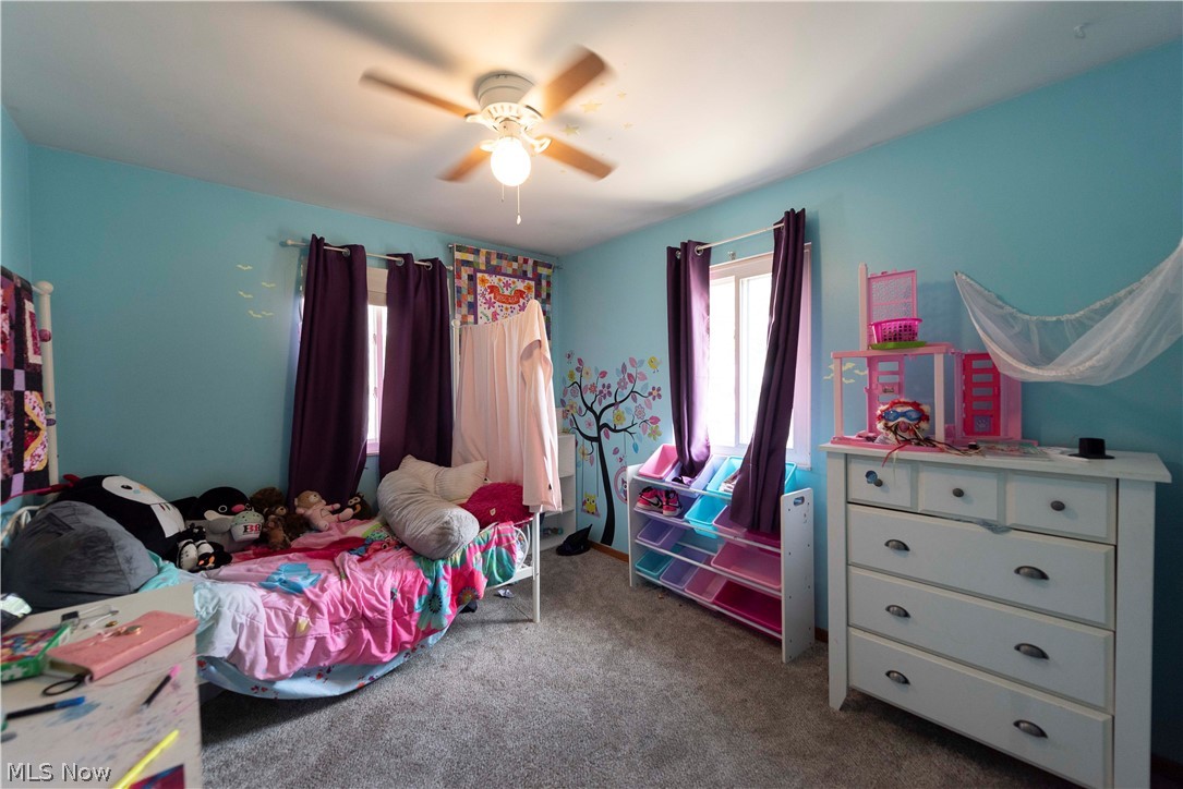 400 Baldwin Road Akron, OH 44312 - Photo 22 of 43 Bedroom 3 featuring a ceiling fan with integrated lighting, a window with dark curtains, and light blue walls