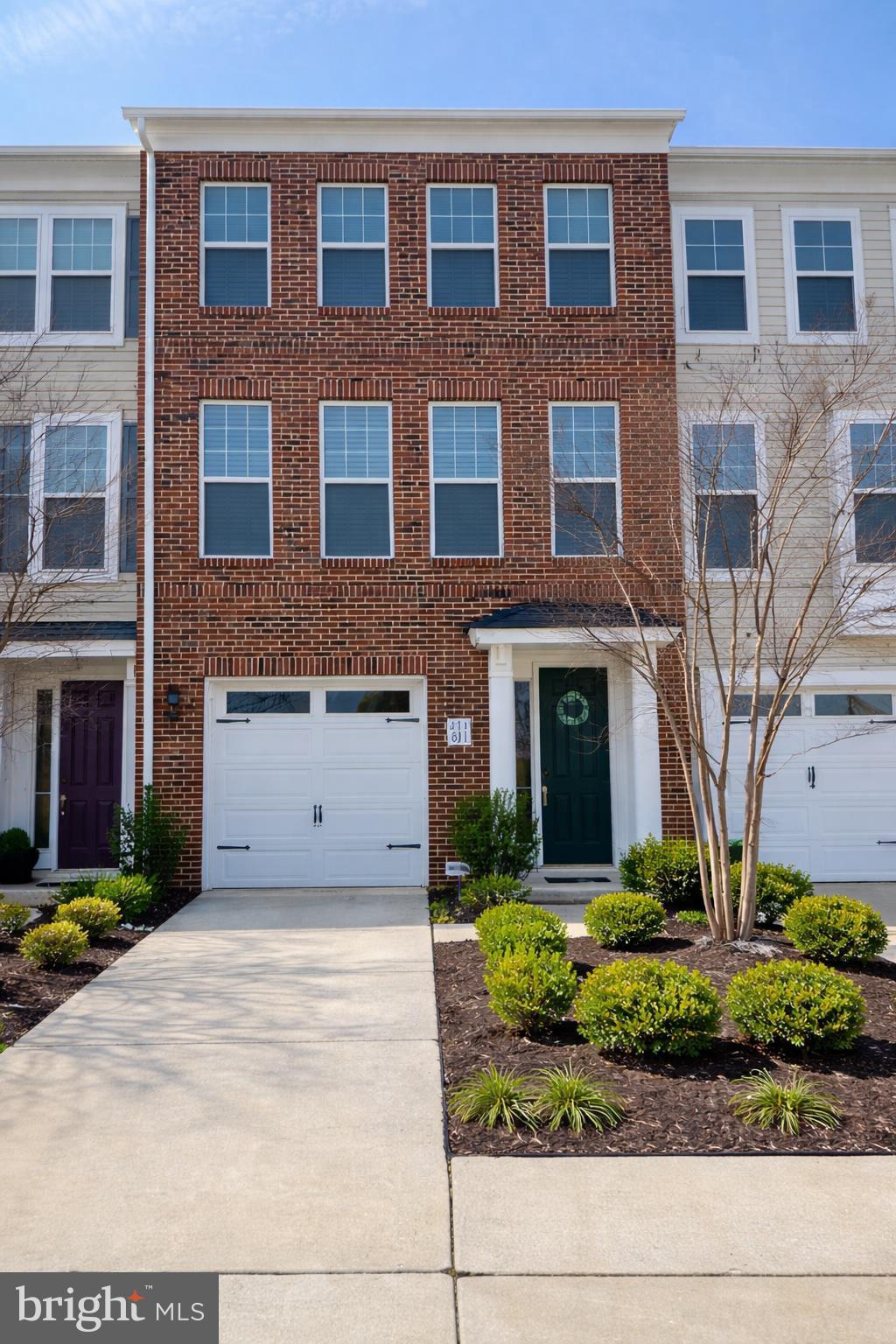Charming brick townhouse with greenery.