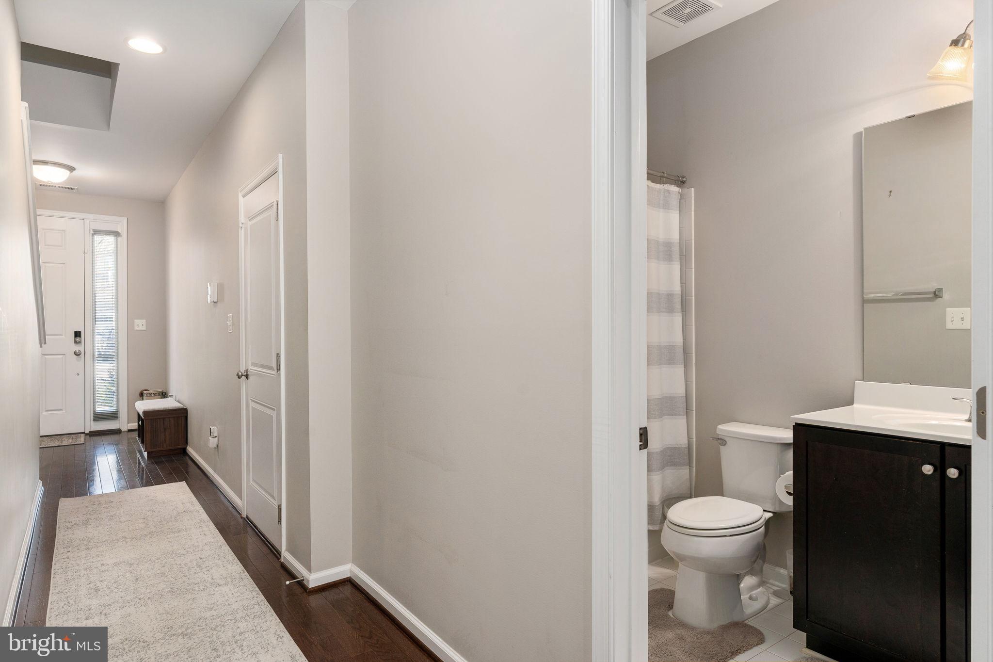 650 Aspen Road, Unit 108 Stafford, VA 22554 - Photo 11 of 30 a bathroom with a granite countertop toilet a sink and a mirror