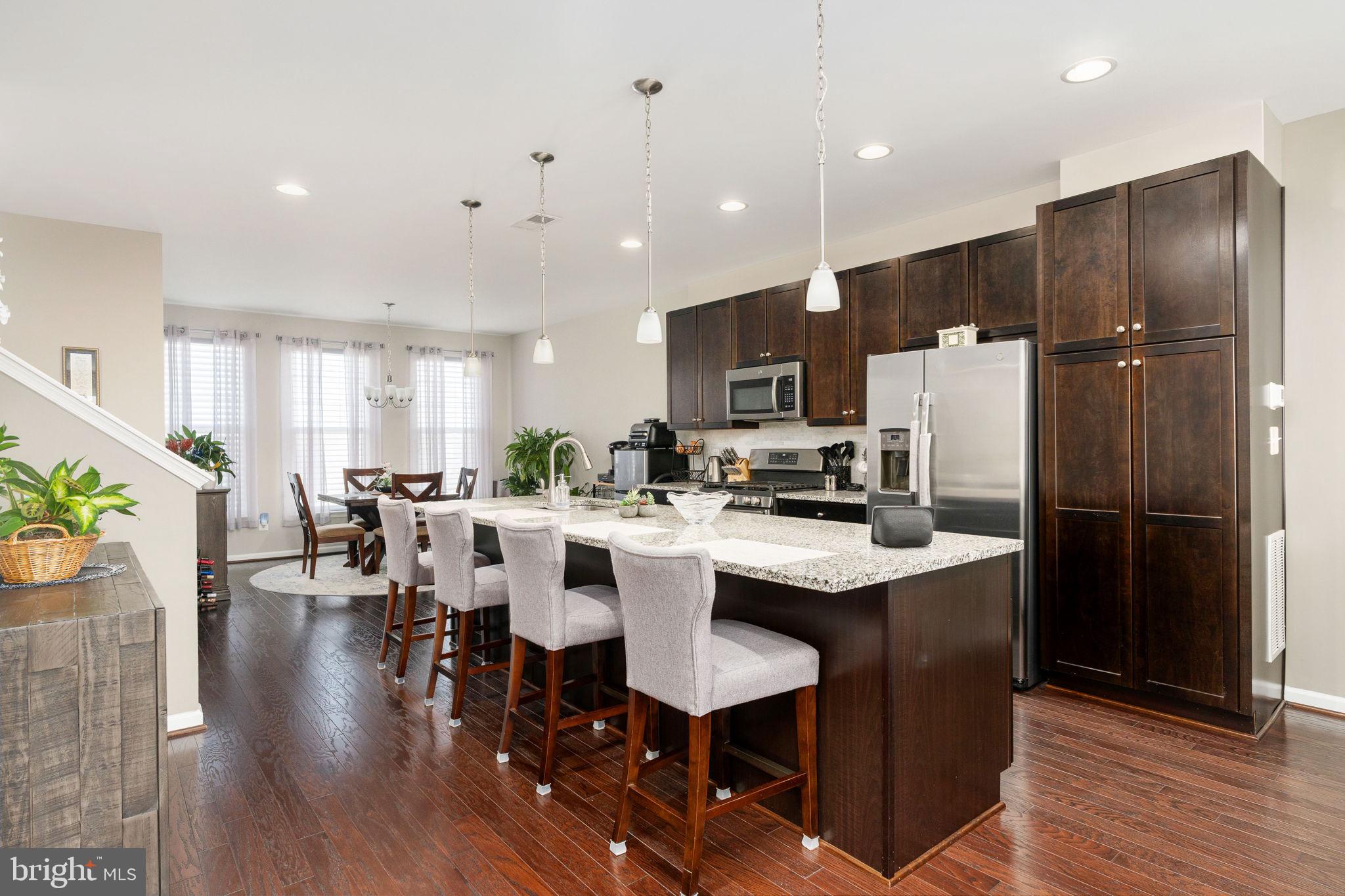 650 Aspen Road, Unit 108 Stafford, VA 22554 - Photo 15 of 30 a kitchen with stainless steel appliances granite countertop a refrigerator a stove a sink a dining table and chairs