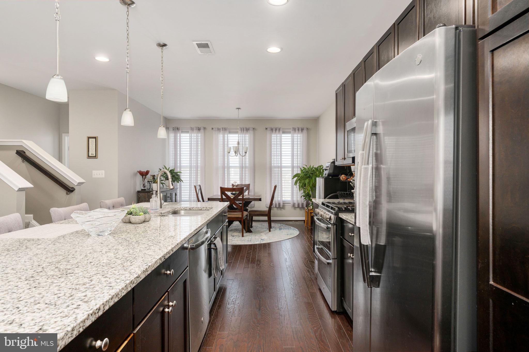 650 Aspen Road, Unit 108 Stafford, VA 22554 - Photo 16 of 30 a kitchen with counter top space a sink appliances and cabinets