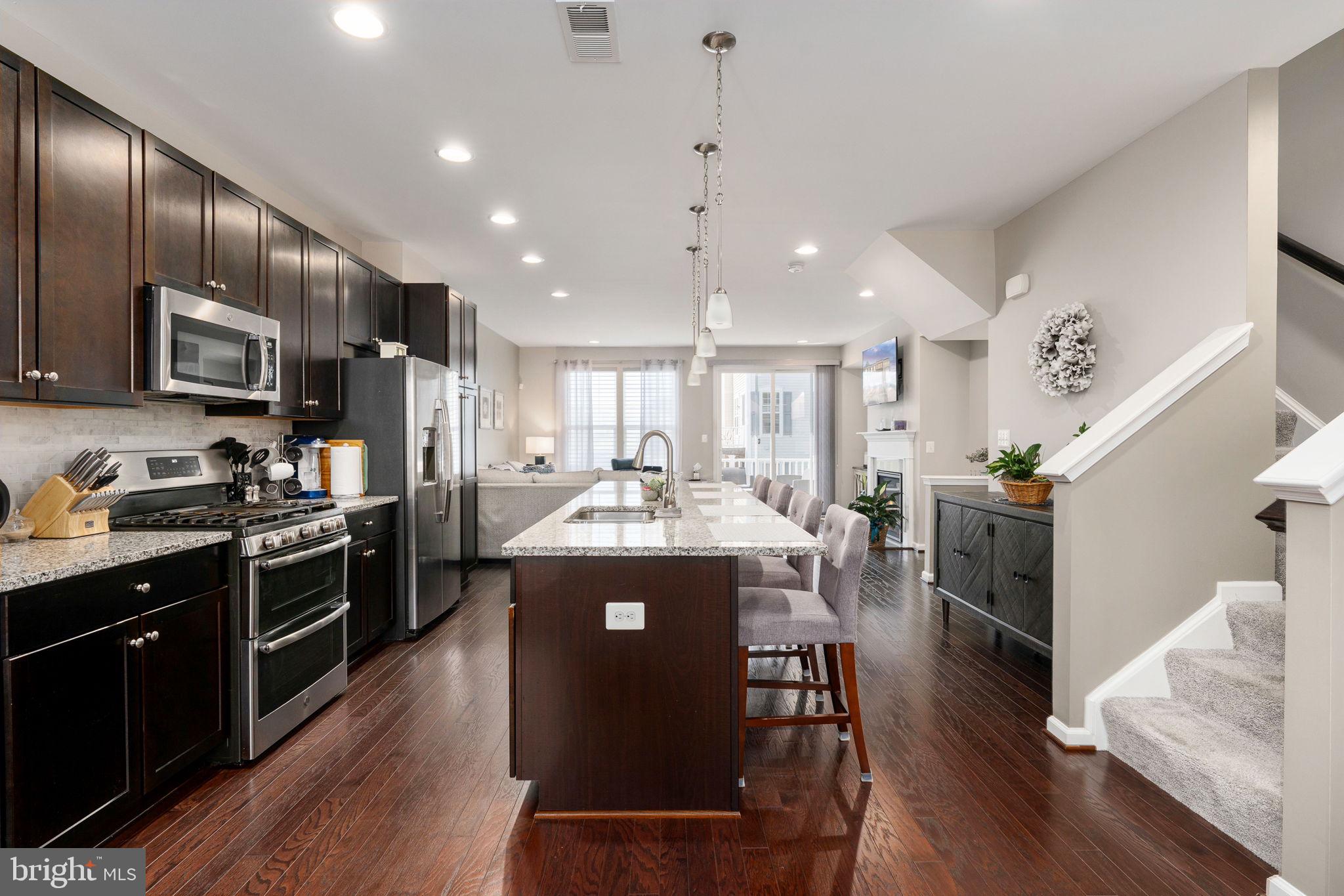 650 Aspen Road, Unit 108 Stafford, VA 22554 - Photo 17 of 30 a kitchen with stainless steel appliances granite countertop lots of counter top space a refrigerator and a stove top oven