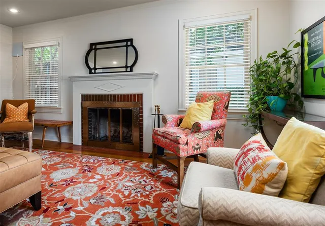 a living room with furniture a window and a fireplace