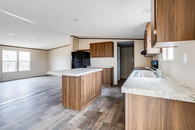 a kitchen with a stove a sink and a refrigerator