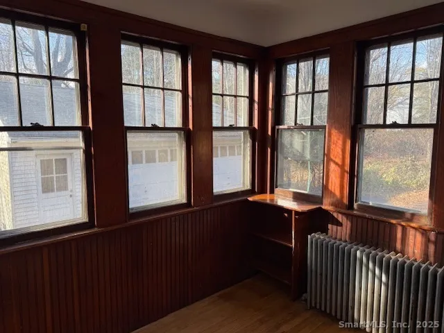 a view of balcony with furniture and large window