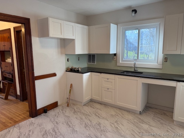 61 Cheshire Road Wallingford, CT 06492 - Photo 10 of 16 a kitchen with white cabinets and window