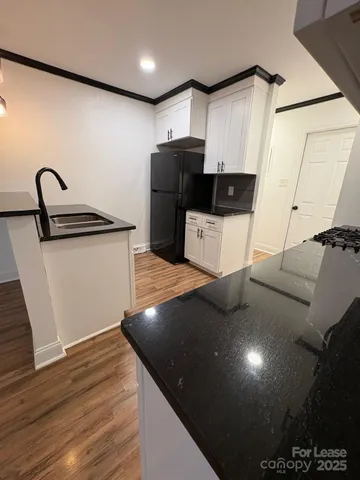 a kitchen with stainless steel appliances a refrigerator sink and cabinets