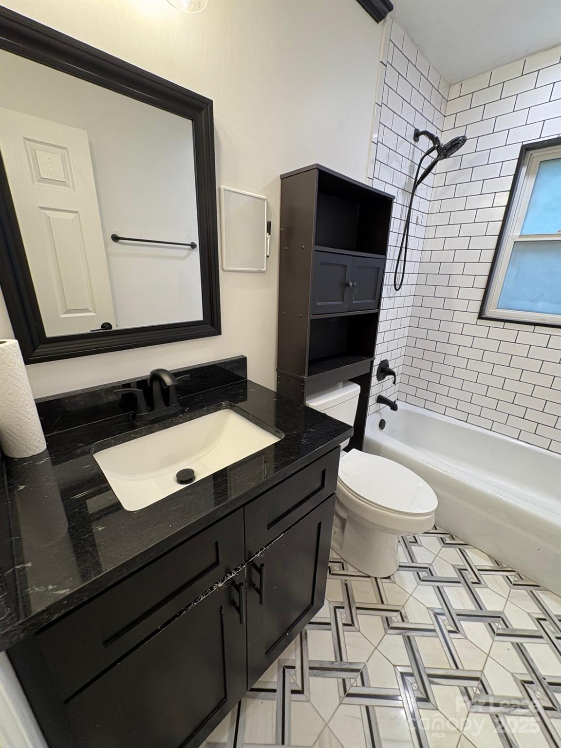 19716 Smith Circle, Unit B Cornelius, NC 28031 - Photo 8 of 8 a bathroom with a toilet a sink and mirror