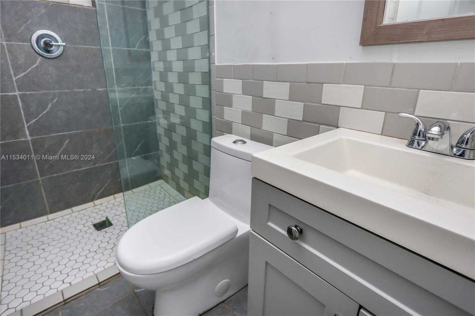 1810 Northwest 34th Street Miami, FL 33142 - Photo 13 of 33 a bathroom with a sink a toilet and shower