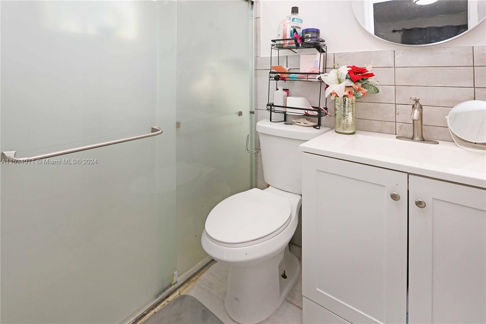 1810 Northwest 34th Street Miami, FL 33142 - Photo 17 of 33 a bathroom with a sink toilet and mirror
