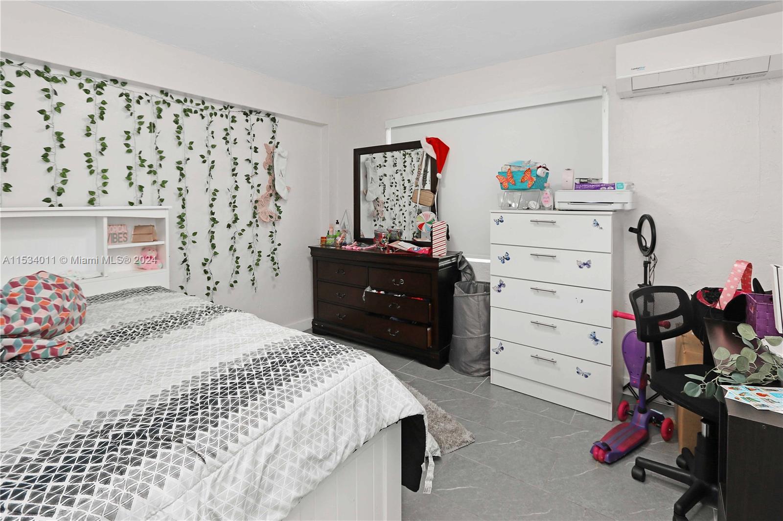 1810 Northwest 34th Street Miami, FL 33142 - Photo 18 of 33 a bedroom with a bed and a dresser
