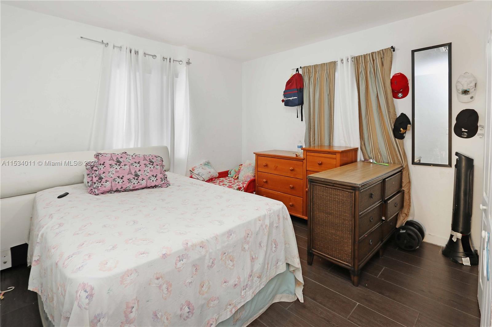 1810 Northwest 34th Street Miami, FL 33142 - Photo 19 of 33 a bedroom with a bed and a window