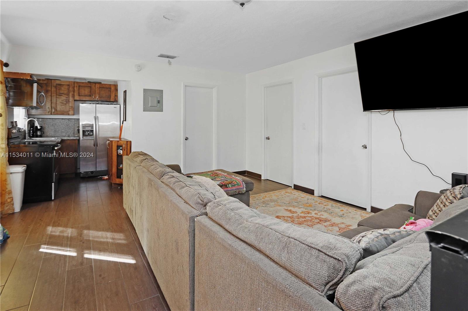 1810 Northwest 34th Street Miami, FL 33142 - Photo 21 of 33 a living room with furniture and a flat screen tv