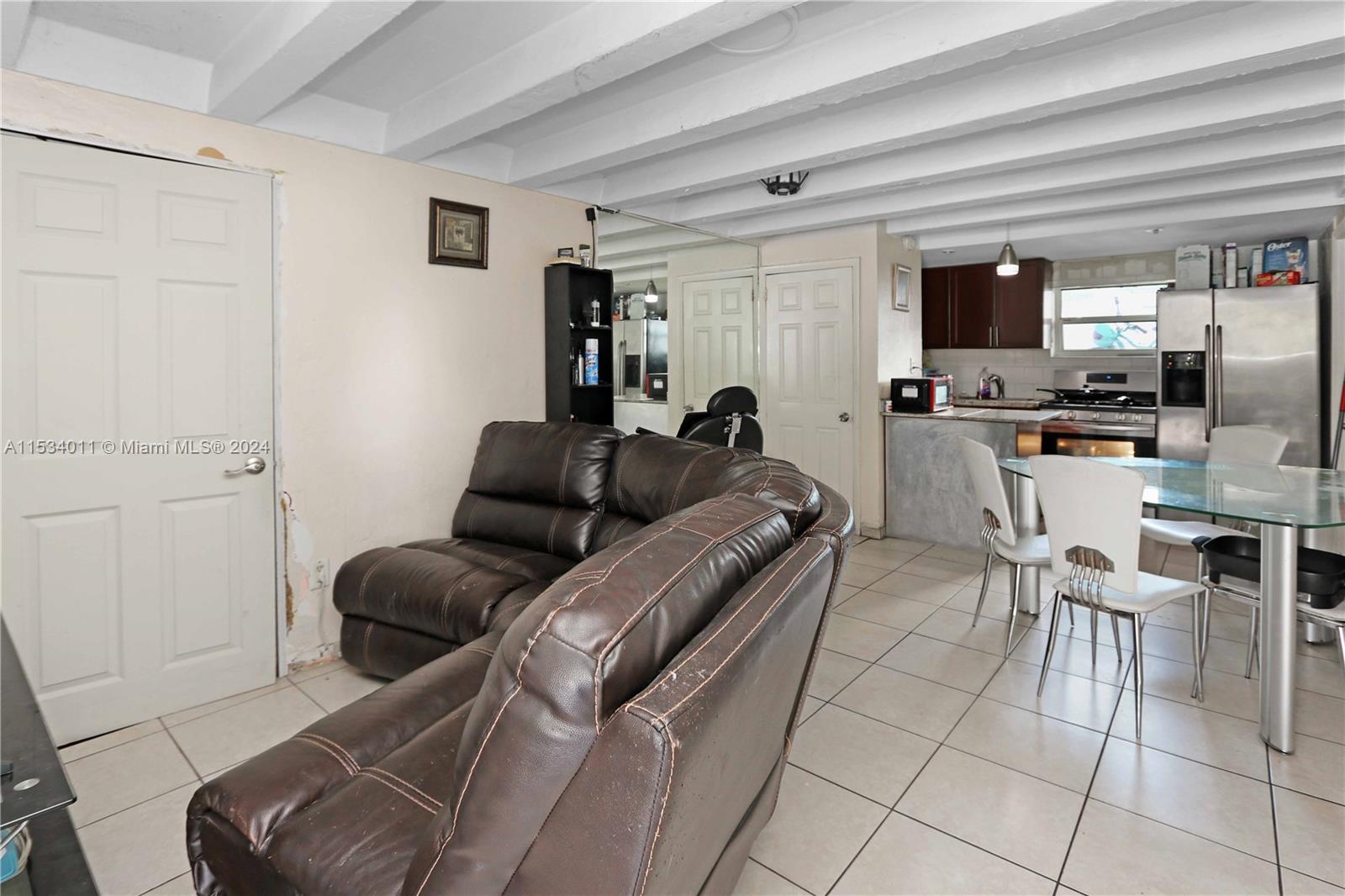 1810 Northwest 34th Street Miami, FL 33142 - Photo 22 of 33 a living room with furniture a flat screen tv and a window