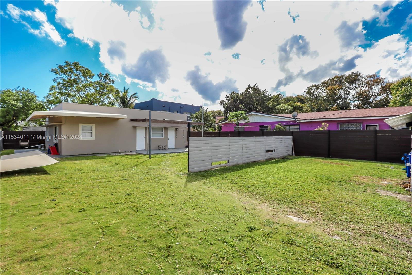1810 Northwest 34th Street Miami, FL 33142 - Photo 25 of 33 a backyard of a house with lots of green space