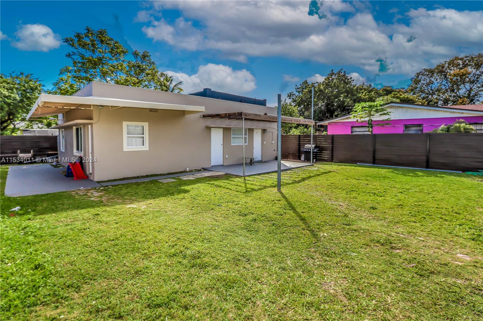 1810 Northwest 34th Street Miami, FL 33142 - Photo 30 of 33 a view of a backyard with a small cabin and potted plants