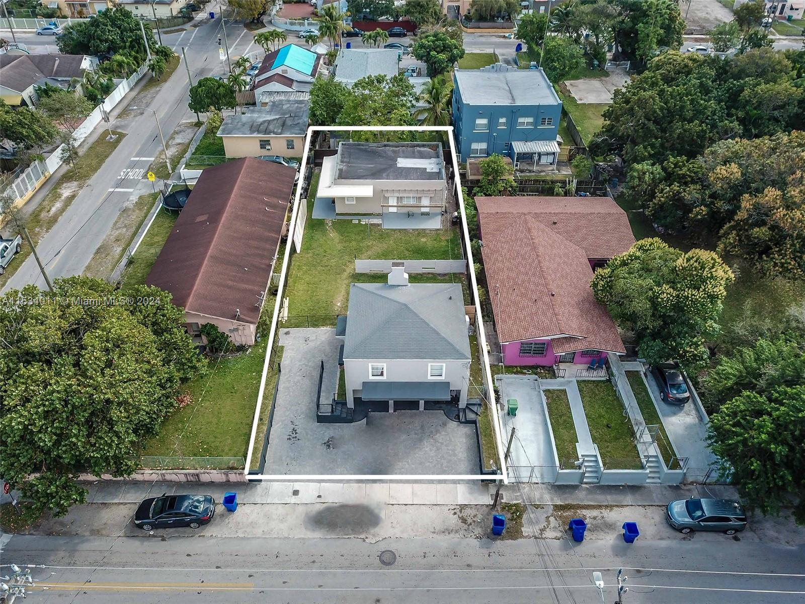 1810 Northwest 34th Street Miami, FL 33142 - Photo 4 of 33 an aerial view of a tennis ground with large trees
