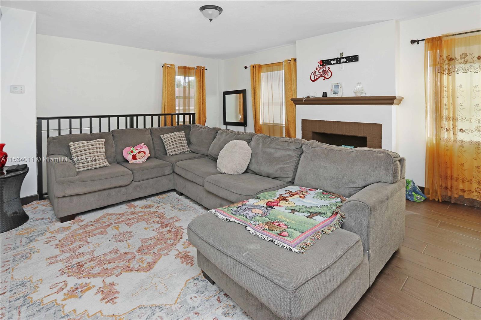 1810 Northwest 34th Street Miami, FL 33142 - Photo 8 of 33 a living room with furniture and a fireplace