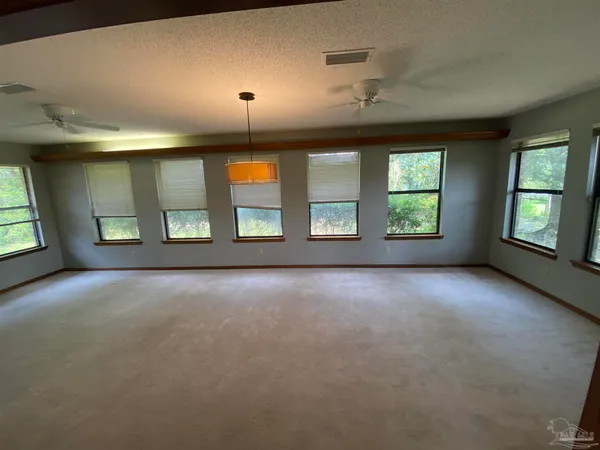 an empty room with windows and entrance