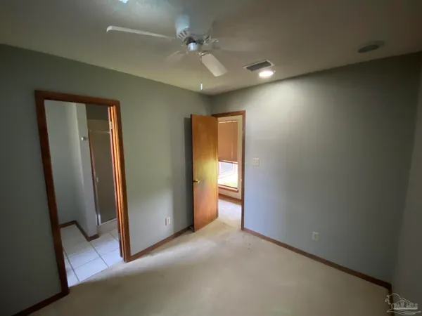 a view of hallway with a bathroom