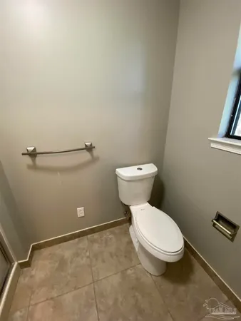 a white toilet sitting next to a shower