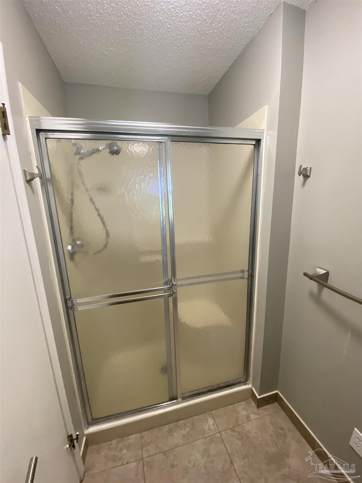 8874 Burning Tree Road Pensacola, FL 32514 - Photo 18 of 22 a bathroom with a glass shower door