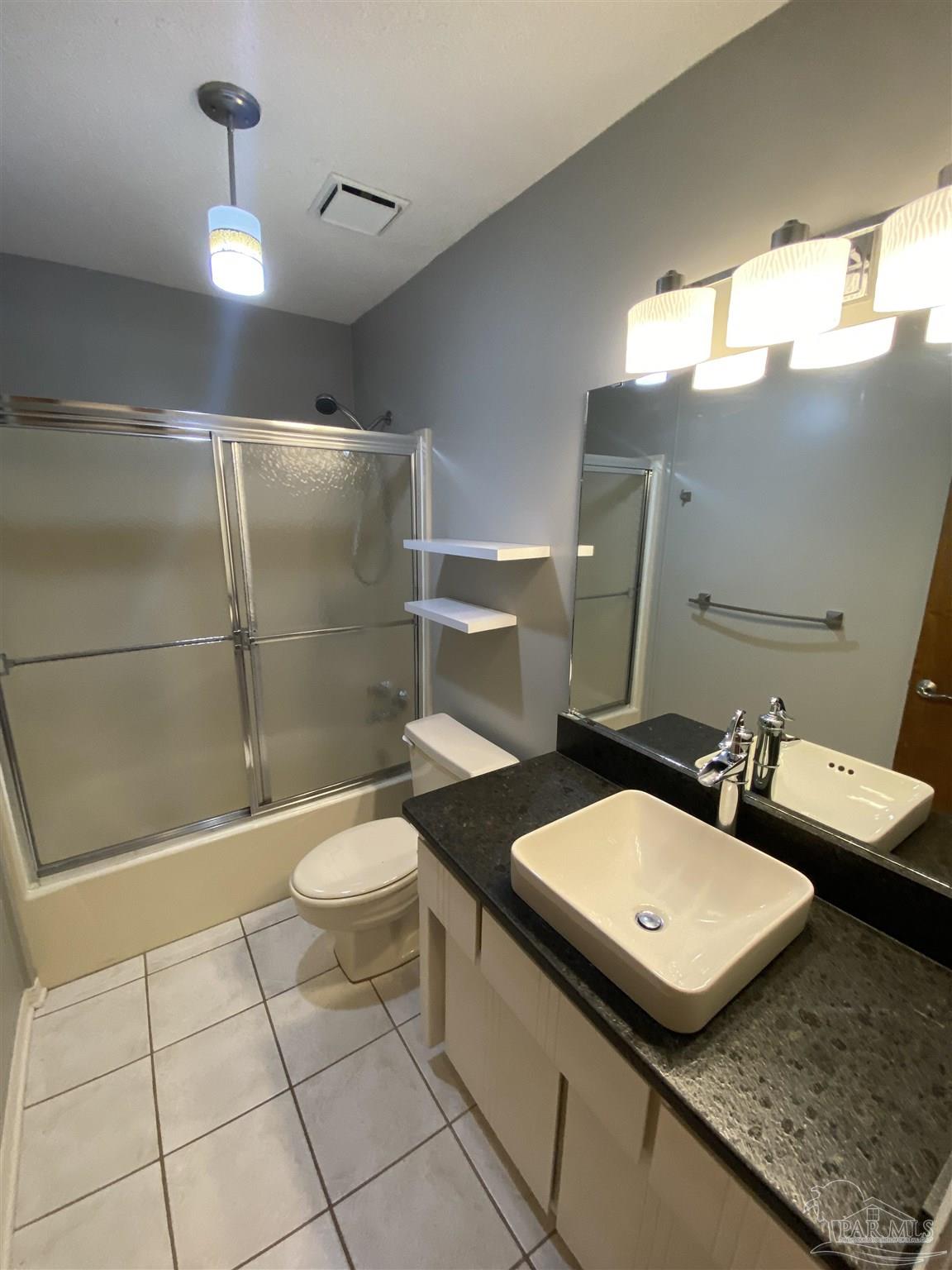 8874 Burning Tree Road Pensacola, FL 32514 - Photo 21 of 22 a bathroom with a toilet a sink and mirror