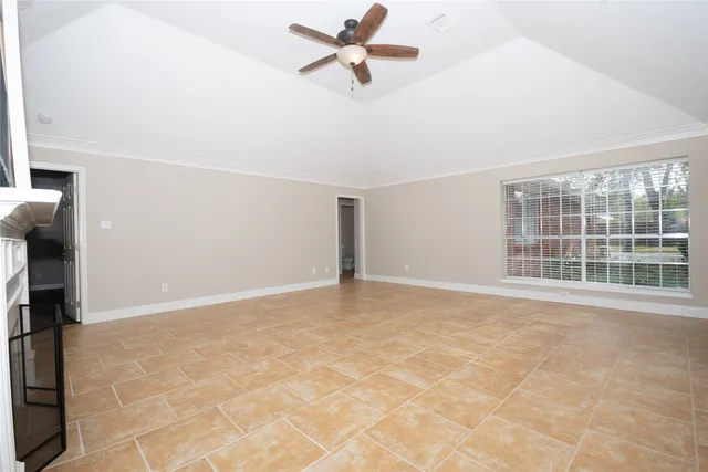 a view of a livingroom with a ceiling fan and window
