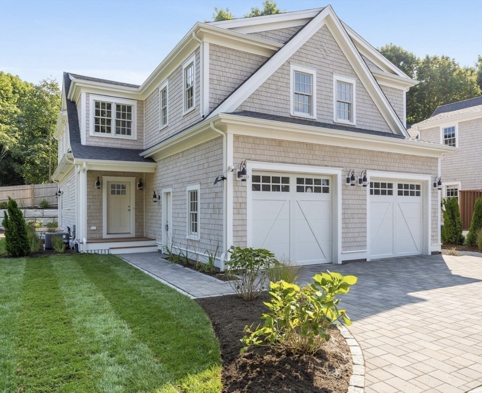 a front view of a house with a garden and plants
