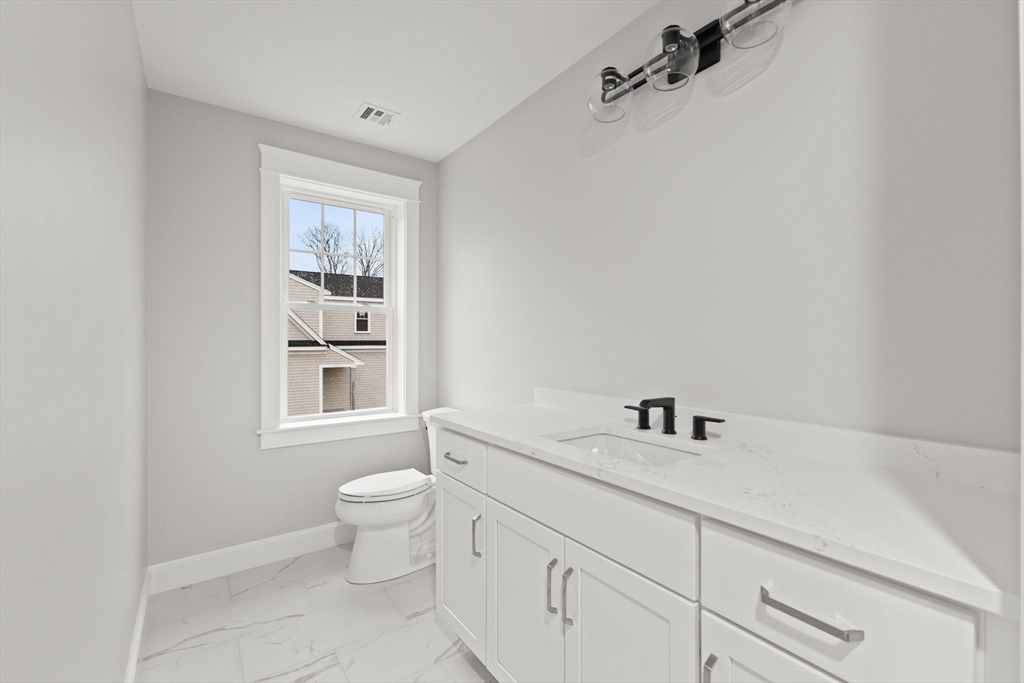 35 Leonard Street, Unit 3 Bridgewater, MA 02324 - Photo 22 of 29 a bathroom with a sink a toilet and a window