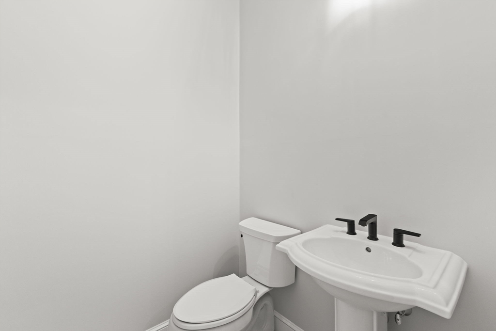 35 Leonard Street, Unit 3 Bridgewater, MA 02324 - Photo 27 of 29 a white toilet sitting next to a white sink