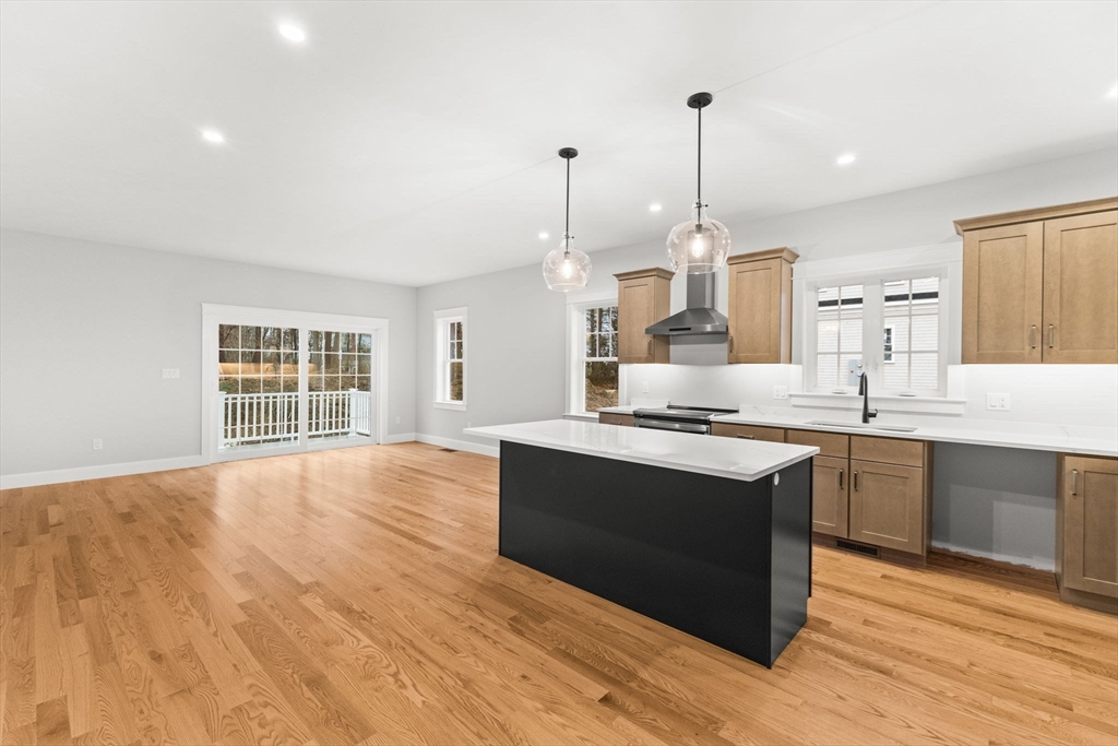 35 Leonard Street, Unit 3 Bridgewater, MA 02324 - Photo 4 of 29 a large kitchen with kitchen island a sink dishwasher a stove and a wooden floor