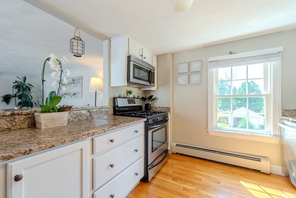 120 Goldsmith Street, Unit 4 Littleton, MA 01460 - Photo 13 of 26 a kitchen with stainless steel appliances granite countertop a sink a stove and a granite counter tops