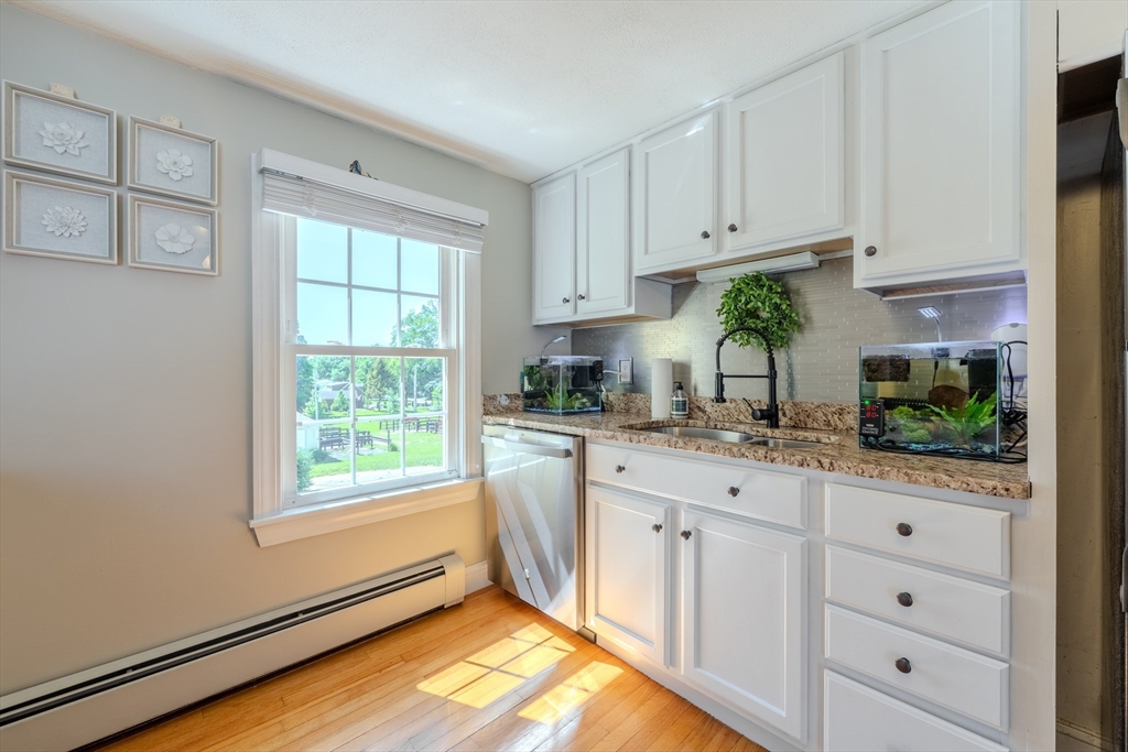 120 Goldsmith Street, Unit 4 Littleton, MA 01460 - Photo 14 of 26 a kitchen with granite countertop white cabinets and white appliances