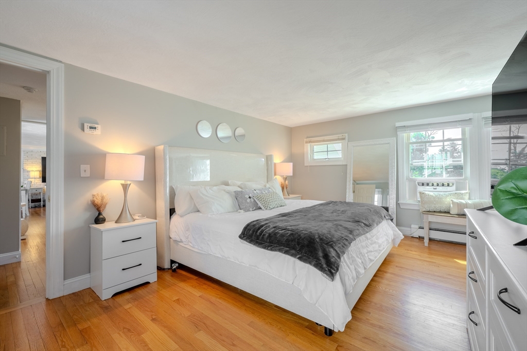 120 Goldsmith Street, Unit 4 Littleton, MA 01460 - Photo 18 of 26 a spacious bedroom with a large bed and wooden floor