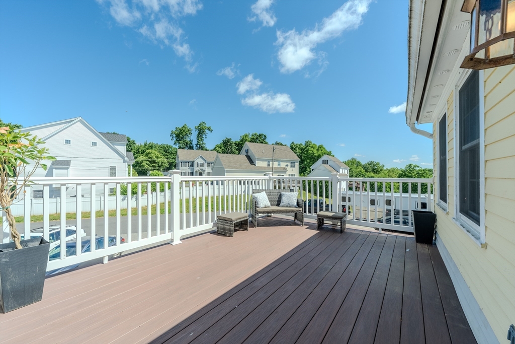 120 Goldsmith Street, Unit 4 Littleton, MA 01460 - Photo 22 of 26 a balcony with hardwood floor