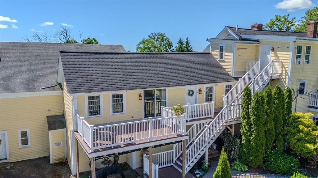 120 Goldsmith Street, Unit 4 Littleton, MA 01460 - Photo 24 of 26 a view of house with a deck and furniture