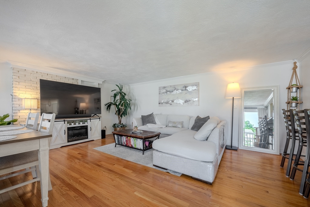 120 Goldsmith Street, Unit 4 Littleton, MA 01460 - Photo 4 of 26 a living room with furniture and a flat screen tv