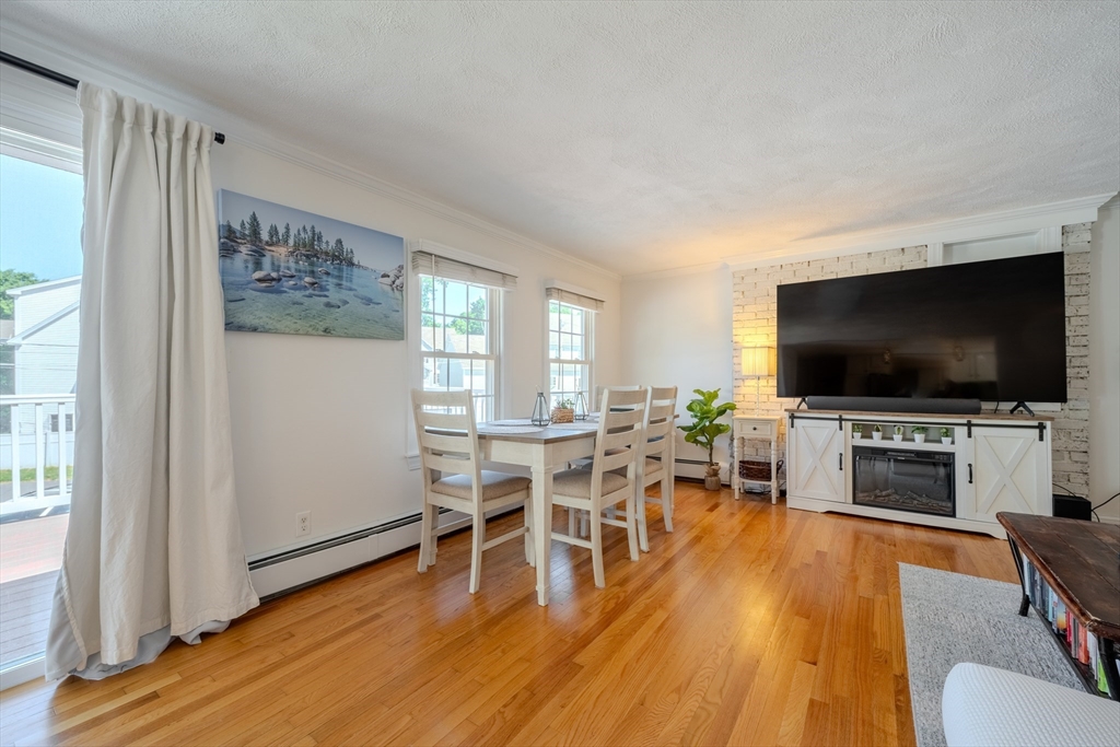 120 Goldsmith Street, Unit 4 Littleton, MA 01460 - Photo 6 of 26 a living room with furniture and a flat screen tv