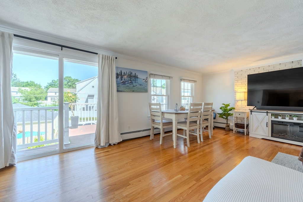 120 Goldsmith Street, Unit 4 Littleton, MA 01460 - Photo 7 of 26 a living room with furniture and a flat screen tv