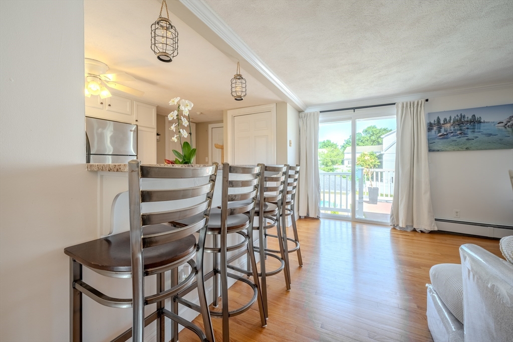 120 Goldsmith Street, Unit 4 Littleton, MA 01460 - Photo 8 of 26 a view of a dining room with furniture and wooden floor