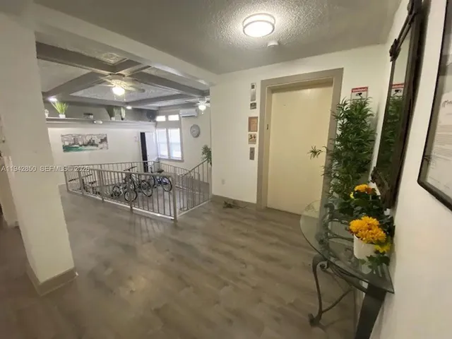 a view of a room with furniture and a chandelier