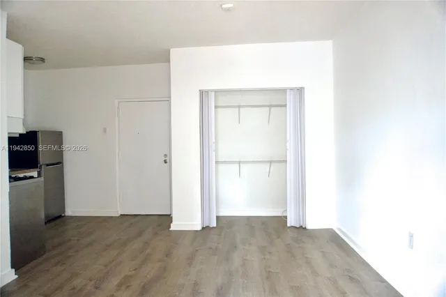 a view of an empty room with closet