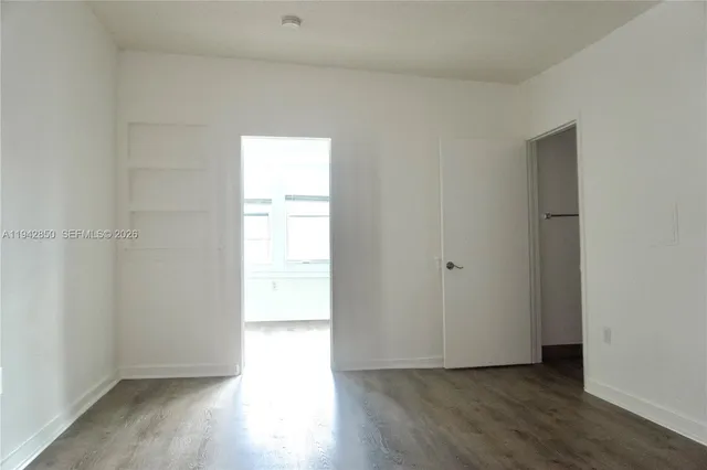 a view of an empty room and wooden floor