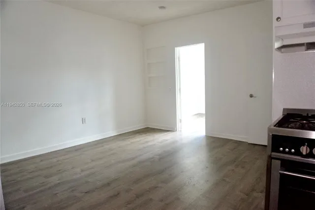 a view of an empty room and wooden floor