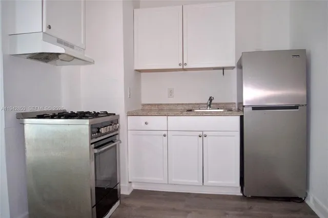 a kitchen with cabinets and stainless steel appliances