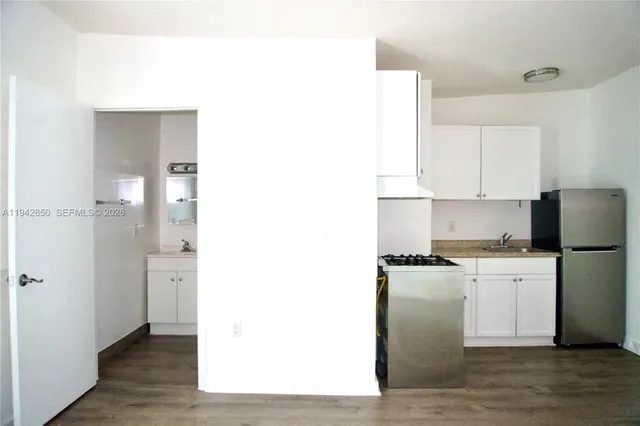 a kitchen with stainless steel appliances granite countertop a refrigerator and a stove